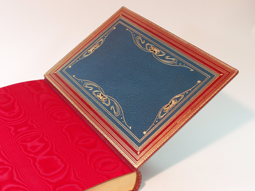 Typical Inner Board (of six) showing the striking Bue Doublure with Art Nouveau  scrolls and Black Onlay Devices (24 in all); Red Moire' Silk Endpapers